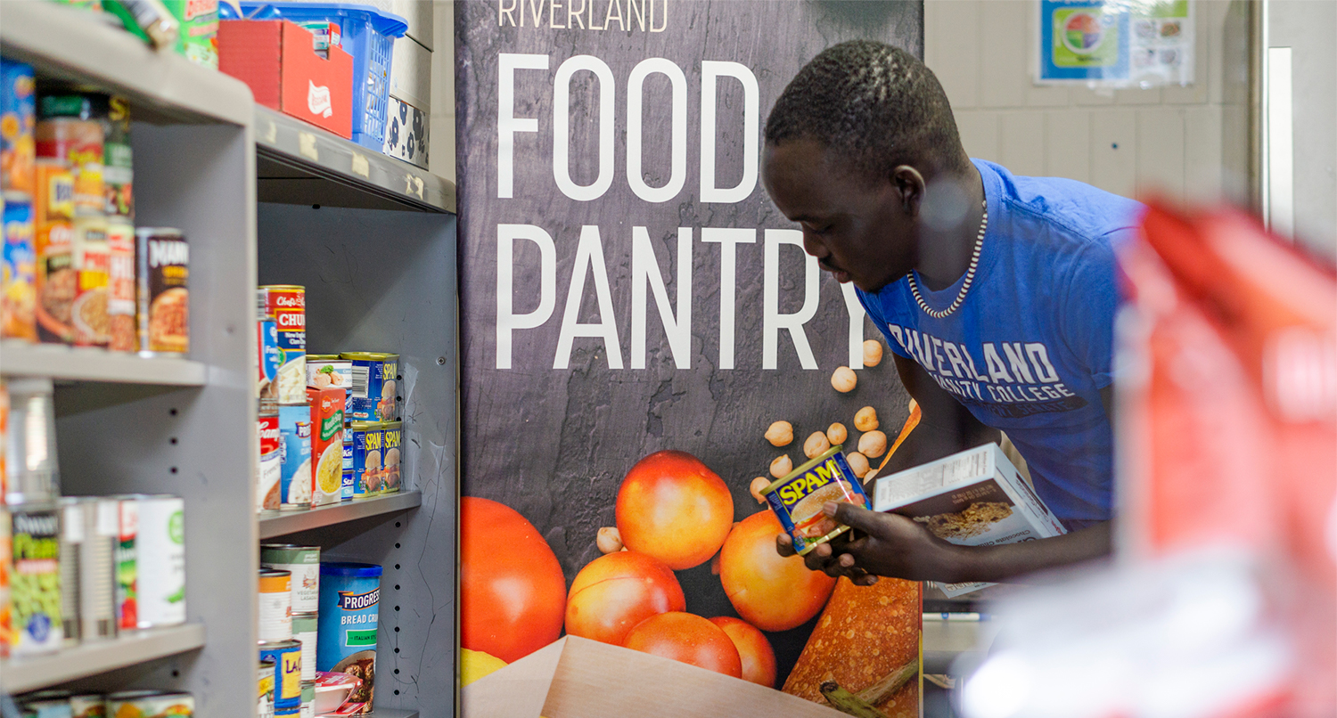 Riverland student stocking shelves in the campus food pantry